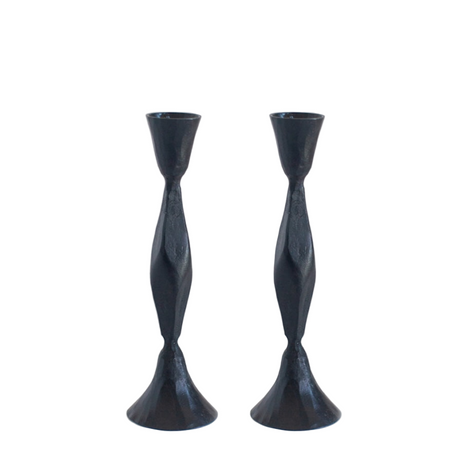 Two black twisted candle holders on a white background