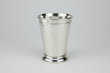 Silver mint julep cup on a light gray background