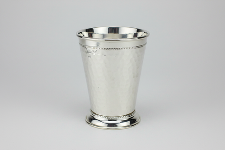 Silver mint julep cup on a light gray background