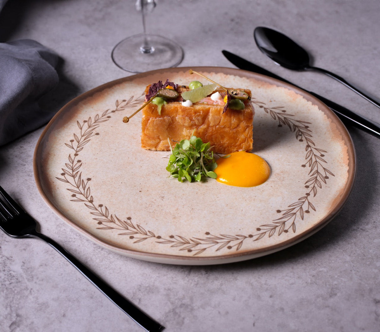 Delicate dish on a decorative plate with a gray background