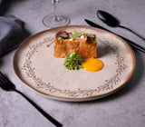 Delicate dish on a decorative plate with a gray background