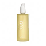 A yellow bottle with a white pump labeled 'AUM' from AUM Skincare, containing a lavender body oil.