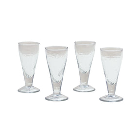 Four clear glass tumblers on a white background