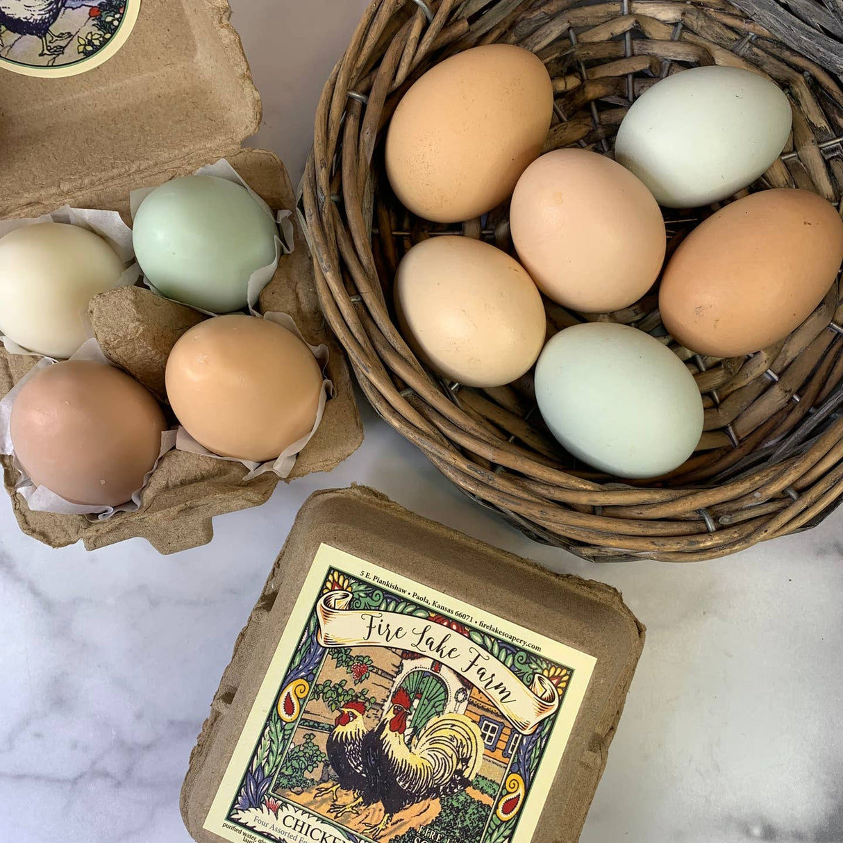 Eggs in a cardboard carton and wicker basket with a 'Fire Lake Farm' label on a marble surface.