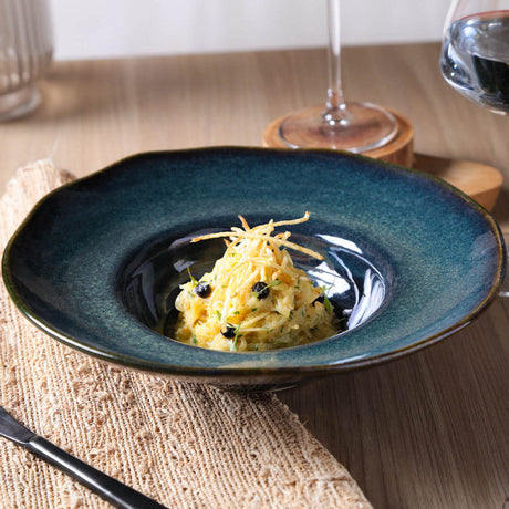 Blue ceramic bowl with a dish on a wooden table