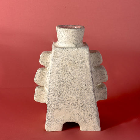 Textured vase on a red background