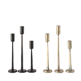 Set of six candle holders in gold and black on a white background