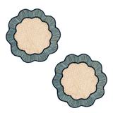 Two decorative placemats with textured surface and blue rim on a white background