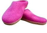 Pair of pink slippers with brown soles on a white background