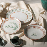 Set of ceramic plates with decorative patterns on a light fabric background
