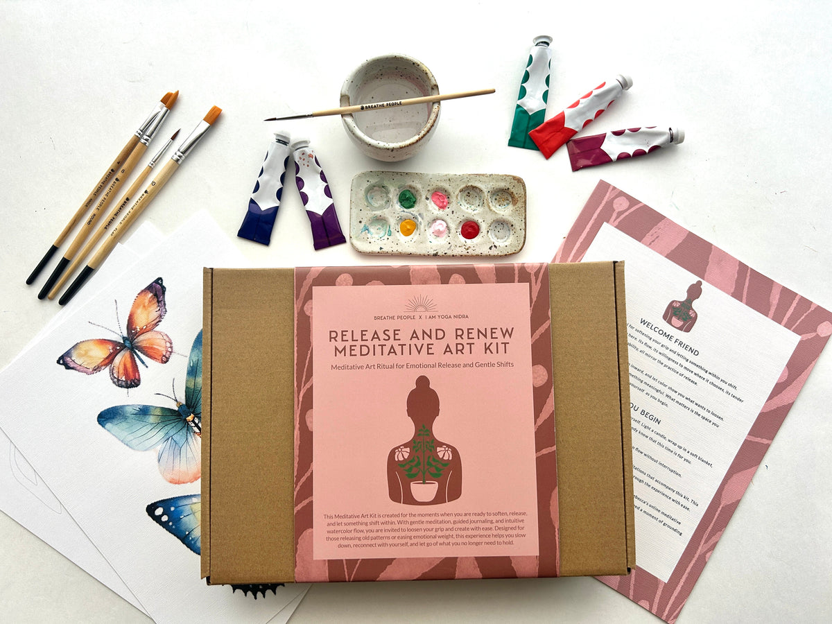 Meditative art kit with packaging, paintbrushes, and art supplies on a white background