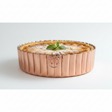 Copper pie dish with a baked pie on a white background