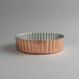 Copper and silver fluted baking dish on a white background