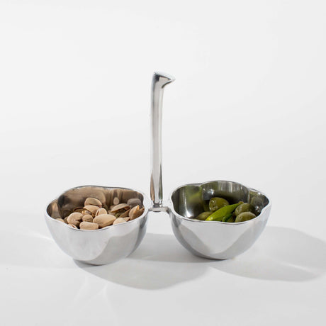 Silver two-compartment bowl with a spoon on a white background