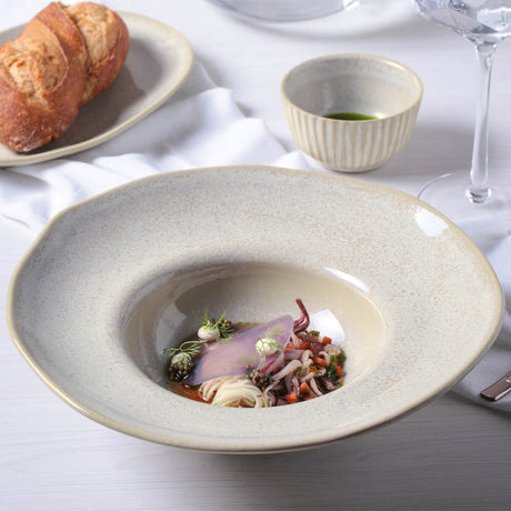 Gourmet dish with a side of bread on a white tablecloth