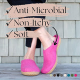 Person wearing pink shoes with text highlighting anti-microbial, non-itchy, and soft features.