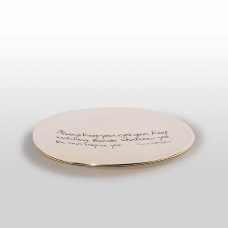 Round ceramic plate with text on a white background
