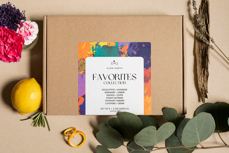 Brown box with a colorful card labeled 'Favorites Collection' on a beige background with flowers and a lemon. 2oz Mini Tins 6 Count