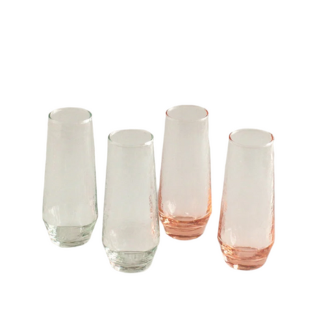 Set of four glass tumblers with pink and clear designs on a white background