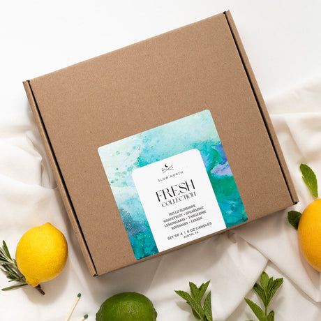 Brown cardboard box with a 'Fresh Collection' label, surrounded by lemons and greenery on a white background