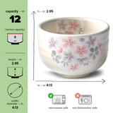 The Kohiki Pink Sakura Ceramic Matcha Bowl from the handcrafted Japanese set features pink floral designs, holds 12 oz, is microwave safe but not for dishwasher use.
