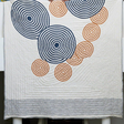 Quilt with circular pattern on a white background