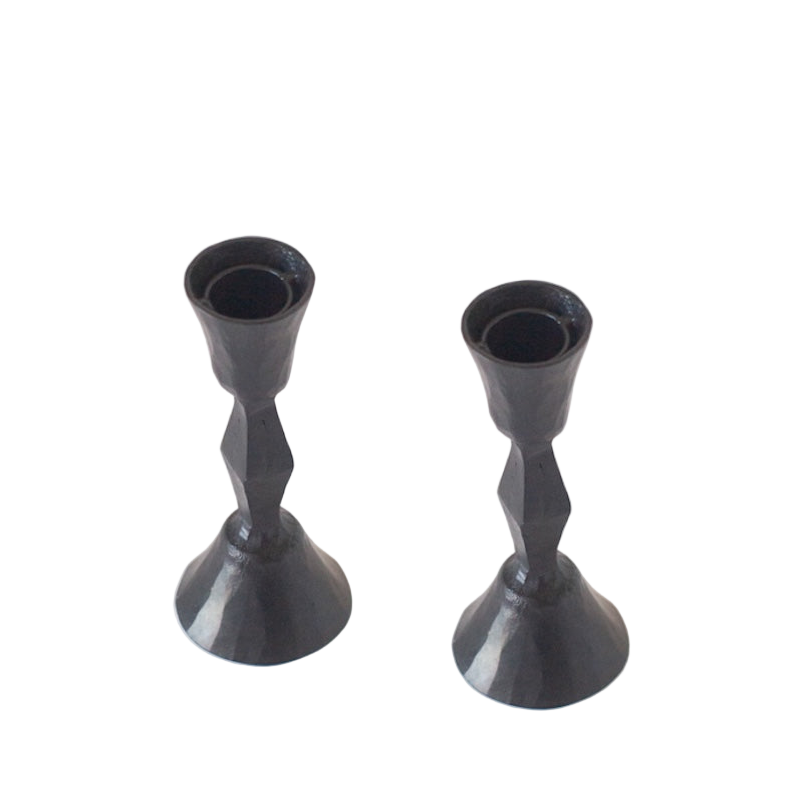 Two black candle holders on a white background