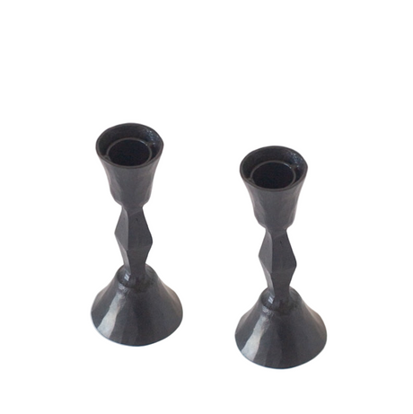 Two black candle holders on a white background