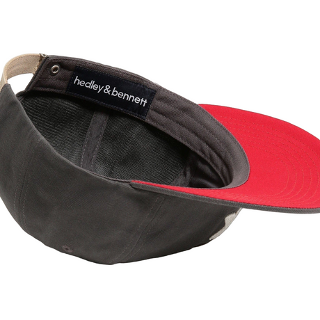 Black and red cap with 'hedley & bennett' label on a white background
