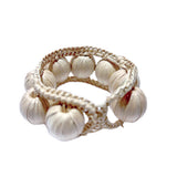 napkin ring made of woven beads on a white background