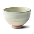 The White Kohiki Ceramic Matcha Bowl, featuring a light green glaze and textured brown base, crafted using Minoyaki pottery techniques, rests elegantly on a white background.