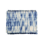 Set of blue and white tie-dye placemats on a white background