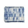 Set of blue and white tie-dye placemats on a white background