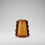 Amber glass vase with decorative brown accents on a beige background