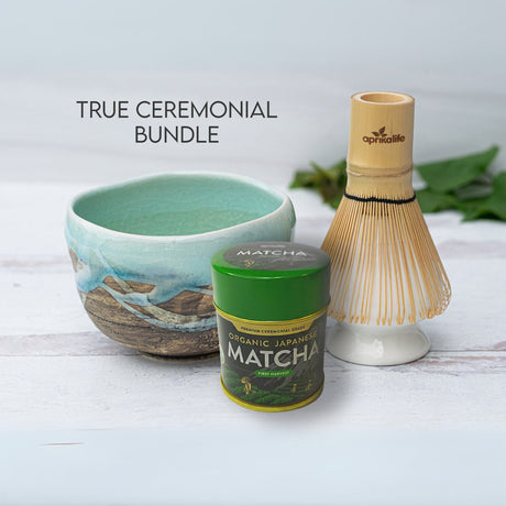 The "True Ceremonial Bundle" features a Japanese Matcha Tea Bowl with Blue & Brown Glaze, a matcha tin, and a bamboo whisk elegantly displayed on a white surface.