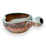 The Brown Ceramic Matcha Bowl with Spout features a multicolored speckled glaze on a black background, making it perfect for matcha and a unique housewarming gift for those who appreciate Japanese tea ceremonies.