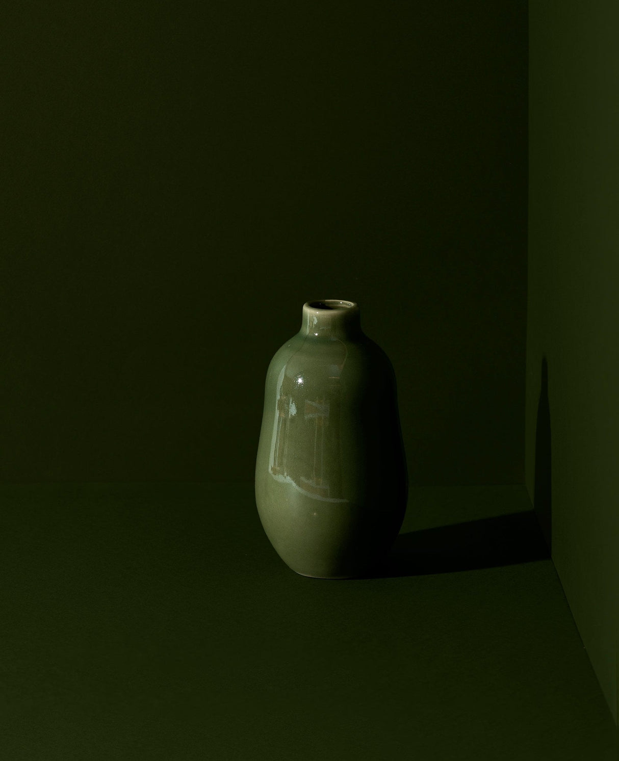 Green ceramic vase on a dark background