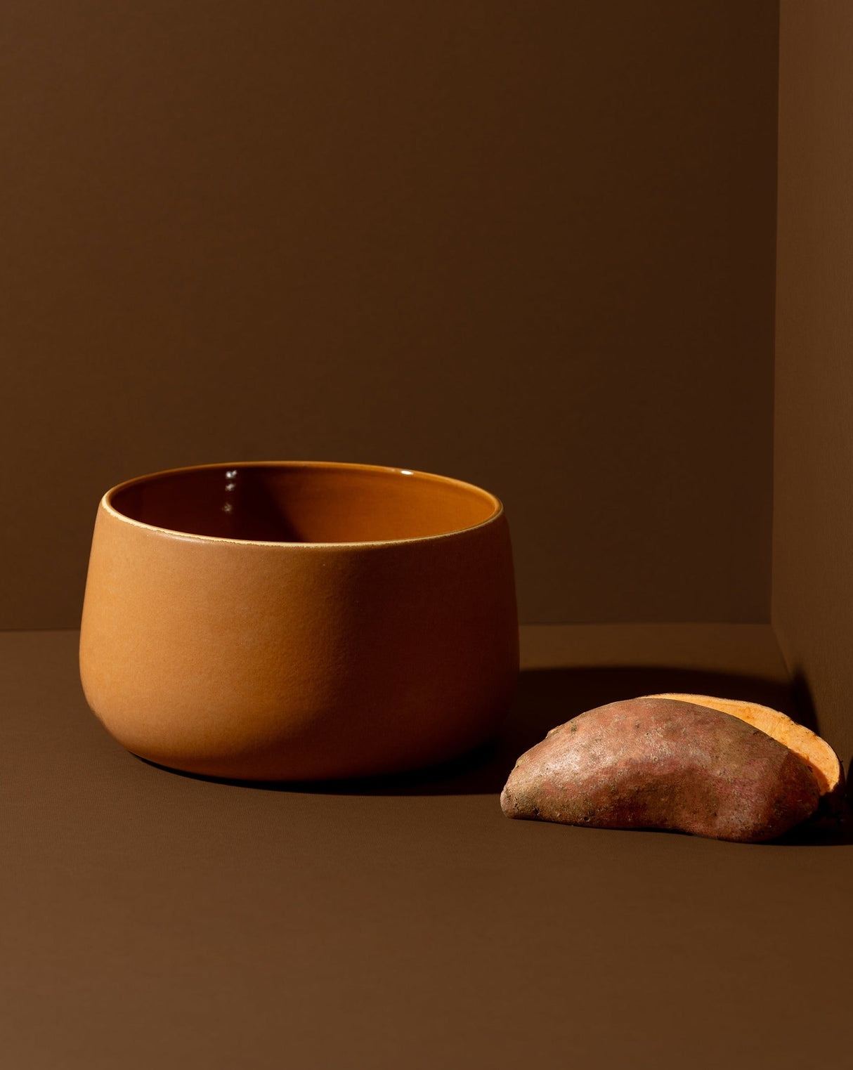 Brown ceramic bowl on a brown surface with a brown background