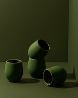 Set of green ceramic cups on a dark background