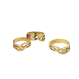 Three gold rings with openwork design on a white background