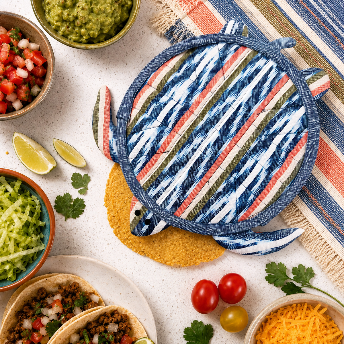 Colorful striped pot holder on a table with taco ingredients and a striped placemat.