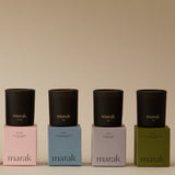Four black candles on colorful boxes with 'marak' branding against a beige background. Collection Votive Set | 3.4oz Soy Wax Scented Candles