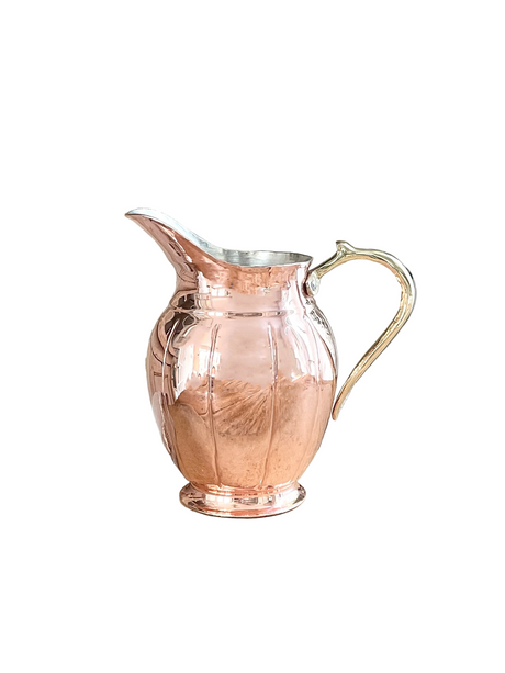 Copper pitcher with a white background