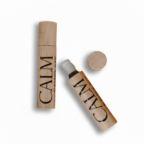 Wooden cosmetic tube labeled 'CALM' on a white background