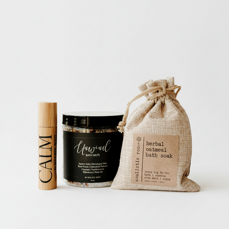 Skincare and bath products including a stick, jar, and bag on a white background