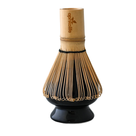 Bamboo whisk with black base on a white background