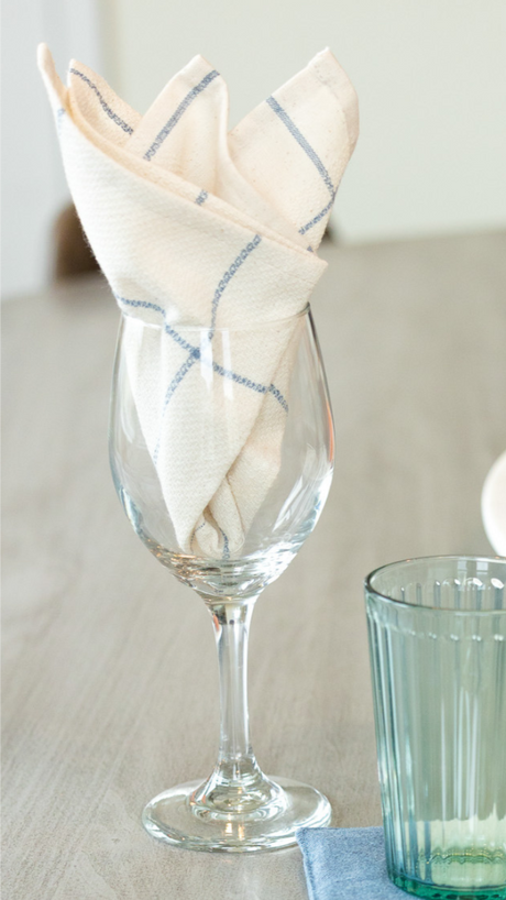 Folded napkin in a wine glass with a blurred background