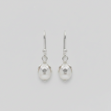 Pair of silver earrings with pearl-like beads on a light gray background