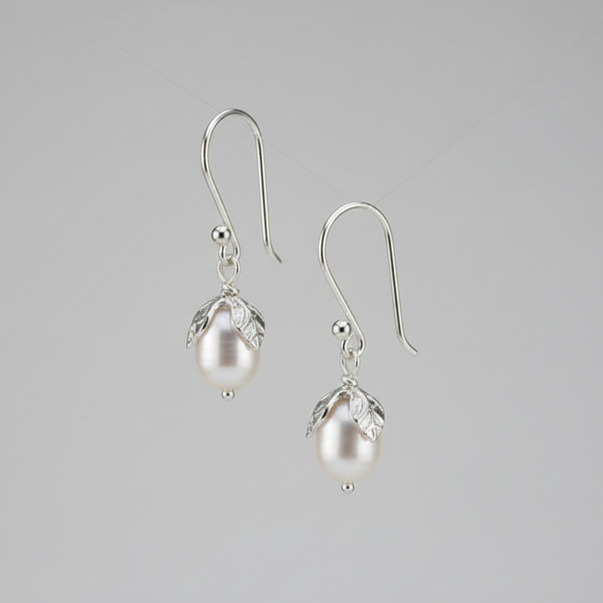 Pair of pearl earrings on a gray background