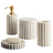 Set of beige bathroom accessories including a dispenser, container, and cup on a white background